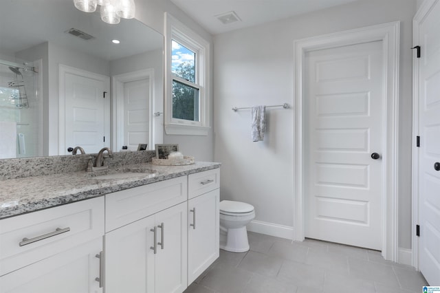 bathroom with visible vents, a shower stall, toilet, and baseboards