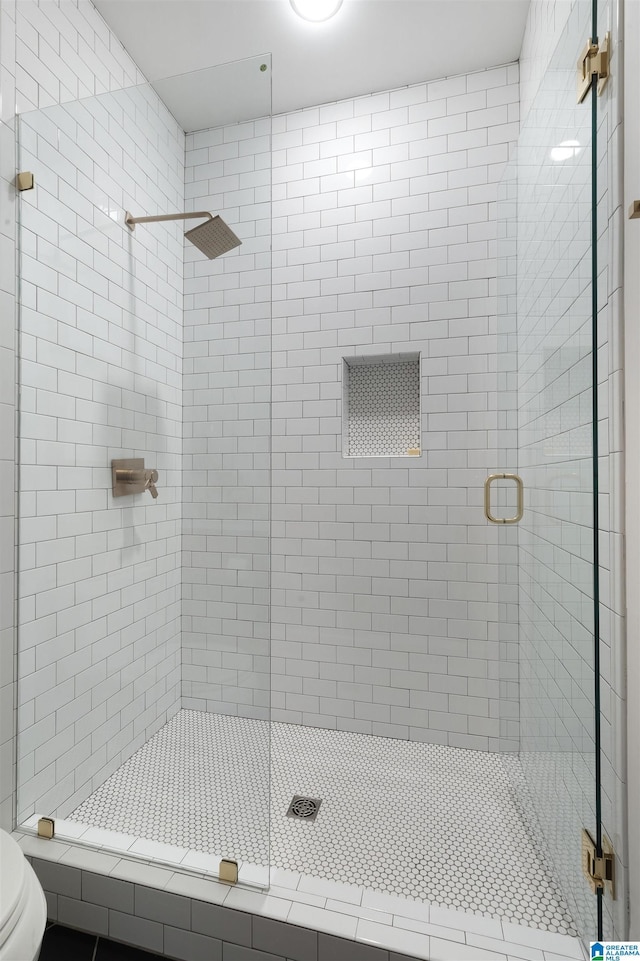 full bath with a shower stall and toilet