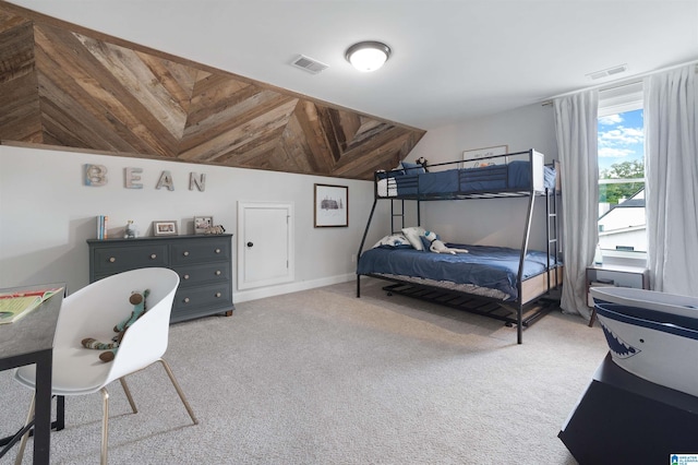 carpeted bedroom featuring visible vents and vaulted ceiling