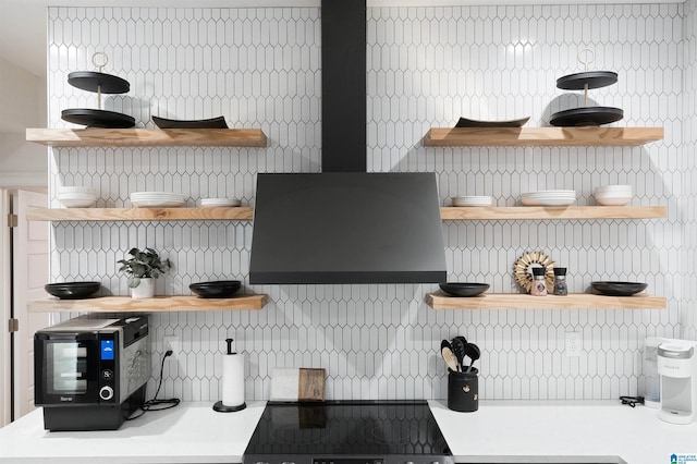 kitchen with ventilation hood, open shelves, light countertops, range, and tasteful backsplash