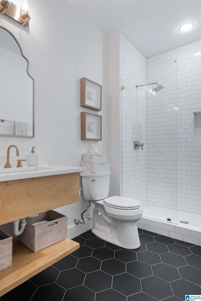 full bathroom featuring tile patterned floors, vanity, toilet, and a shower stall