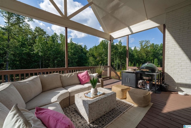 wooden terrace featuring a grill and an outdoor hangout area