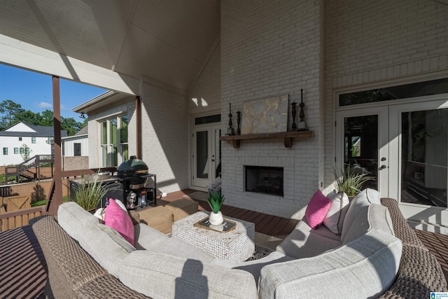 view of patio / terrace with an outdoor living space with a fireplace, french doors, and a grill