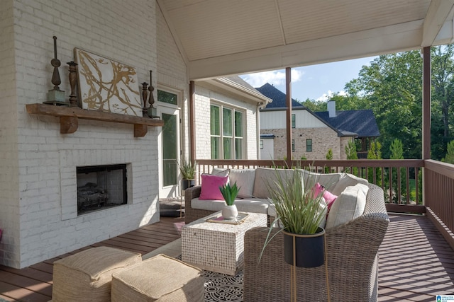 wooden terrace featuring an outdoor living space with a fireplace