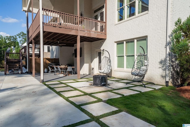 view of patio with a wooden deck and stairs