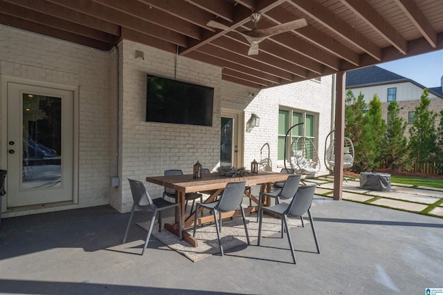 view of patio with outdoor dining space and ceiling fan