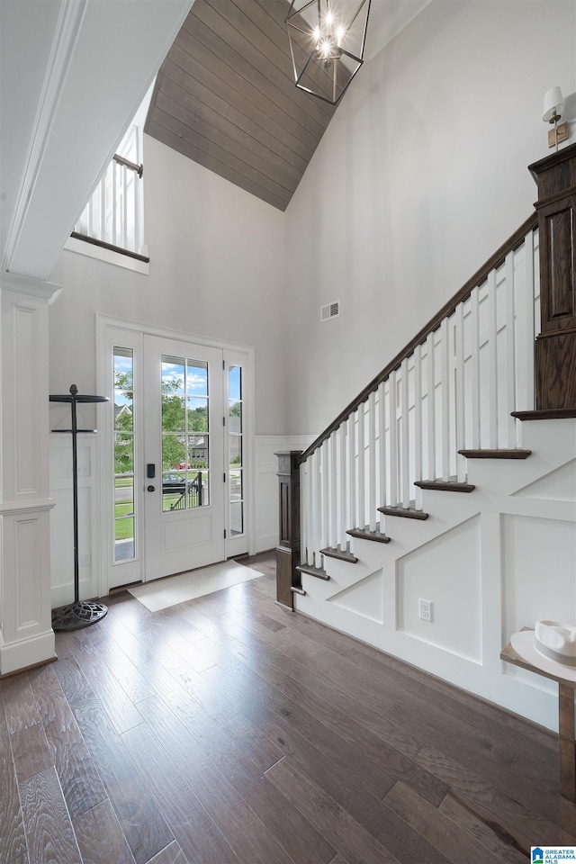 foyer entrance with visible vents, wood finished floors, and stairs