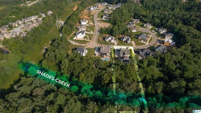 aerial view featuring a residential view and a wooded view