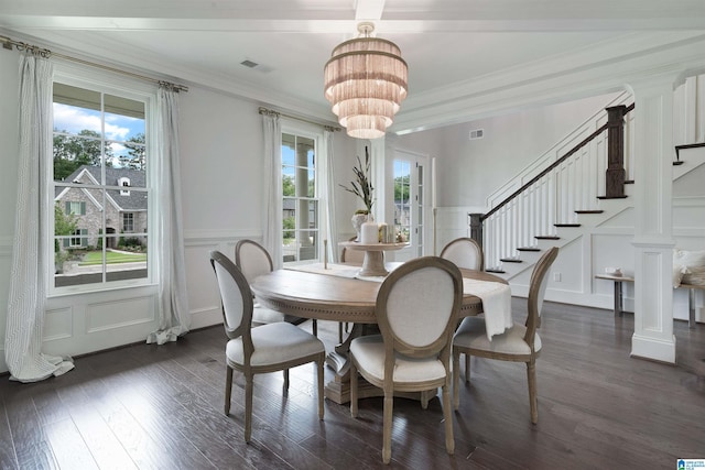 dining space with a chandelier, a decorative wall, and plenty of natural light