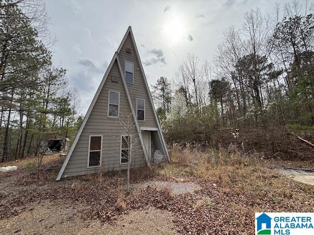 view of side of property featuring a barn