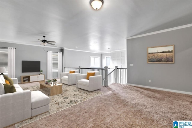 living room featuring ceiling fan, carpet floors, ornamental molding, and baseboards