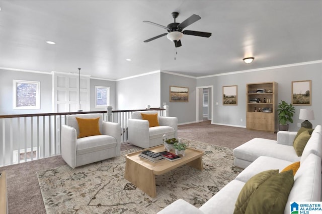 carpeted living area with a ceiling fan, visible vents, ornamental molding, and baseboards