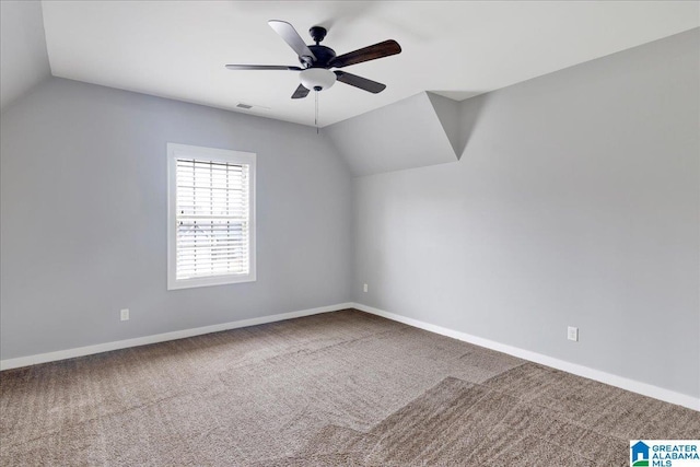 additional living space with ceiling fan, carpet, visible vents, and vaulted ceiling