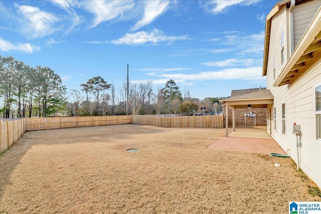 view of yard with ceiling fan, a patio, and a fenced backyard