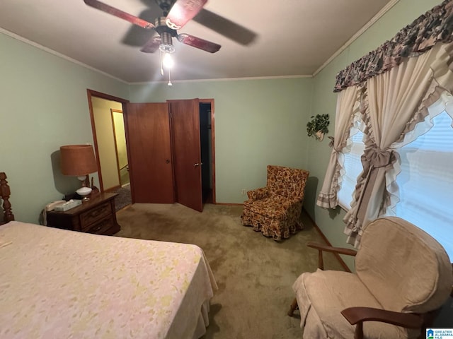 bedroom with carpet floors, ceiling fan, and crown molding