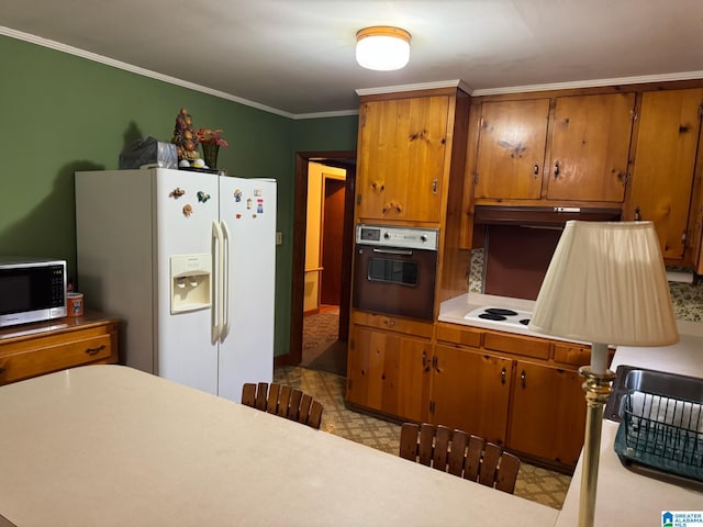 kitchen with light floors, white appliances, light countertops, and brown cabinets