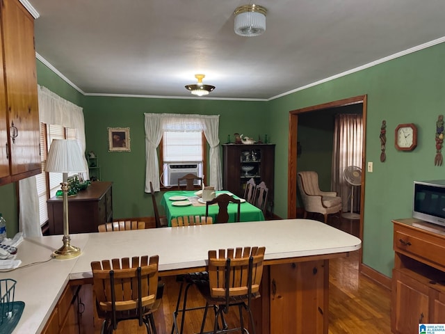 interior space featuring wood finished floors, cooling unit, and crown molding