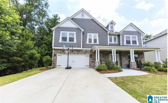 craftsman-style house featuring concrete driveway, a front lawn, a porch, and an attached garage