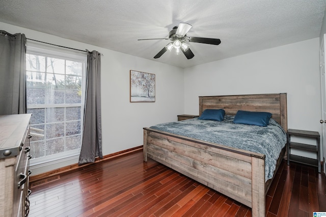 bedroom with a textured ceiling, ceiling fan, wood finished floors, and baseboards