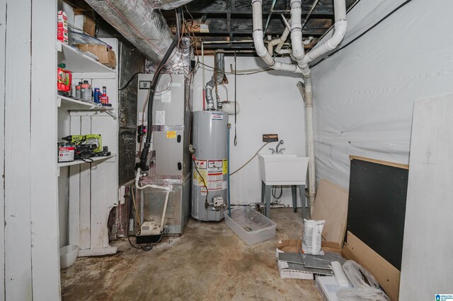 utility room featuring a sink, heating unit, and gas water heater