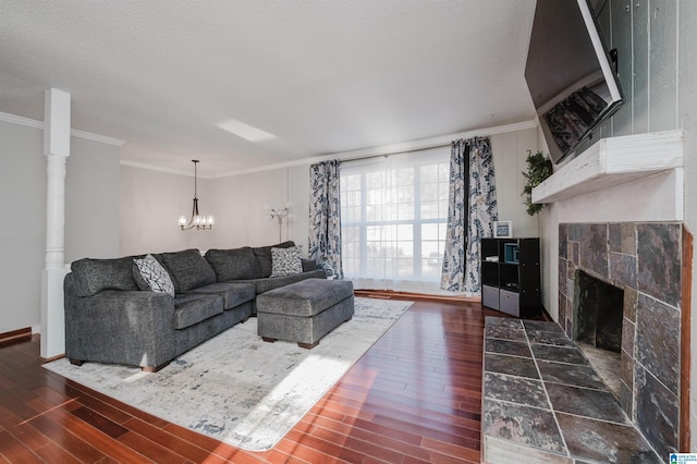 living room with ornamental molding, a fireplace, and wood finished floors