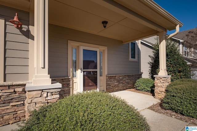 property entrance with stone siding