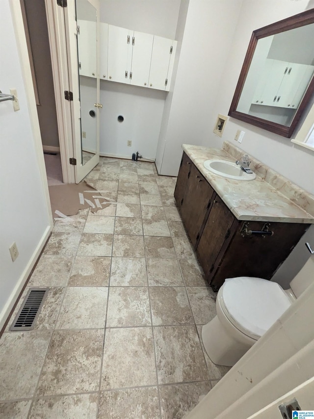 bathroom featuring visible vents, vanity, and toilet