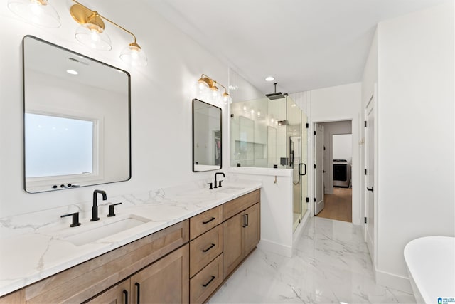 full bathroom with marble finish floor, a freestanding tub, a sink, and a stall shower