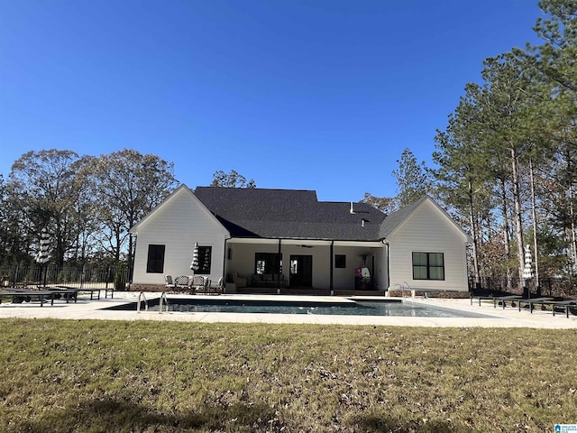 rear view of house featuring a yard, a patio area, fence, and a ceiling fan