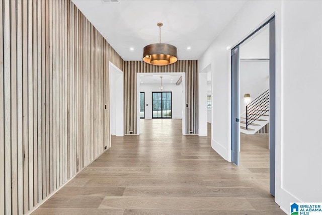 hall with stairway, recessed lighting, and light wood-style floors