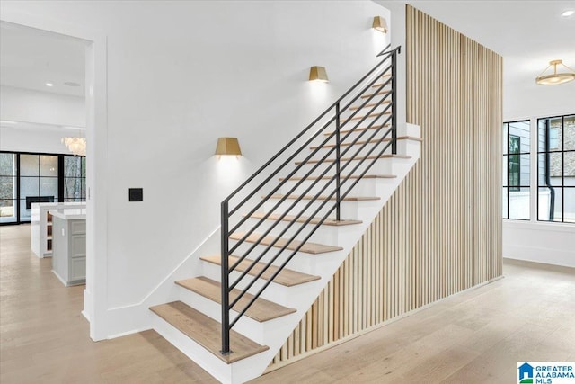 stairs with recessed lighting, baseboards, and wood finished floors