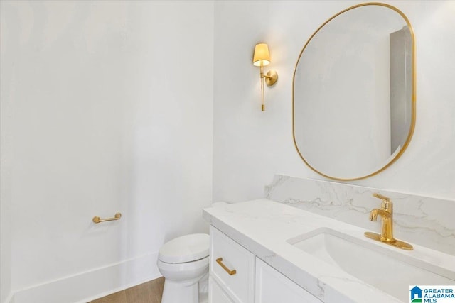 bathroom featuring toilet and vanity