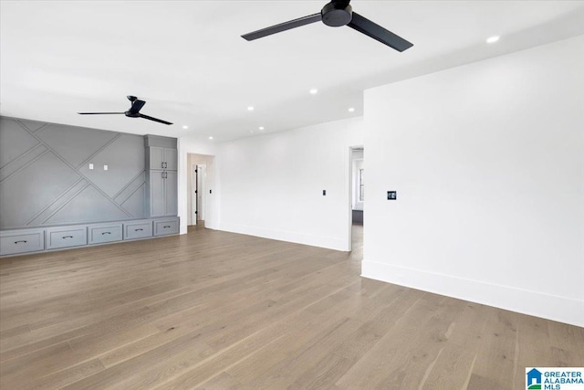 unfurnished living room featuring recessed lighting, light wood-style flooring, baseboards, and ceiling fan