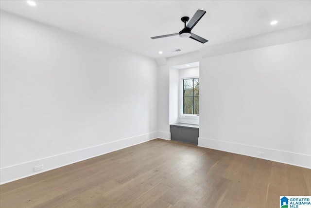 unfurnished room featuring visible vents, a ceiling fan, wood finished floors, recessed lighting, and baseboards