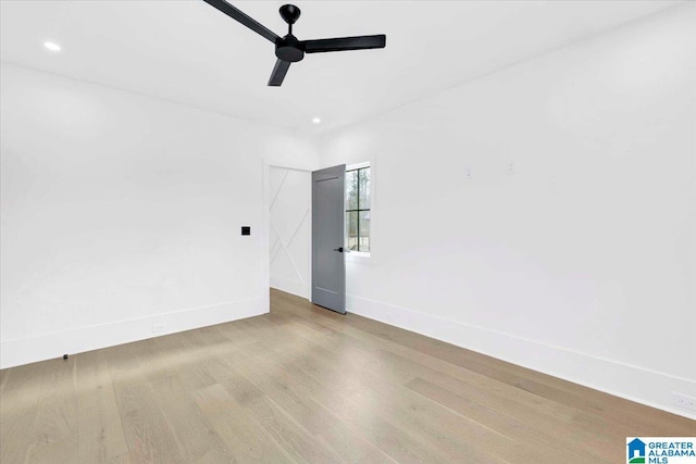 empty room with recessed lighting, ceiling fan, baseboards, and wood finished floors