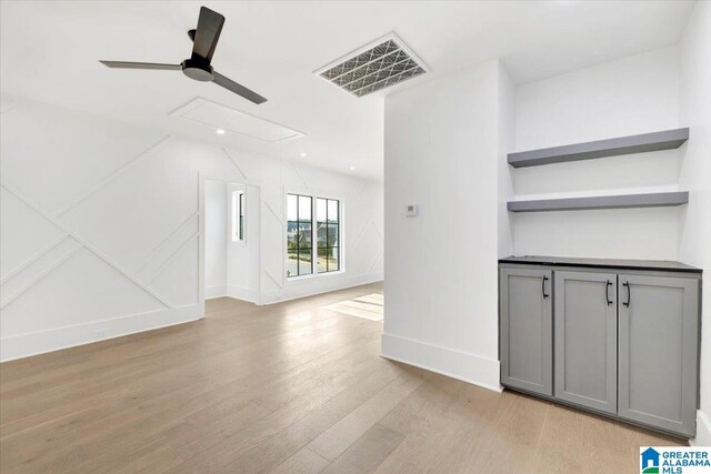 unfurnished living room featuring baseboards, visible vents, attic access, recessed lighting, and light wood-type flooring