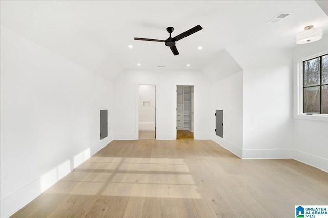 interior space featuring visible vents, baseboards, light wood-style floors, and a walk in closet