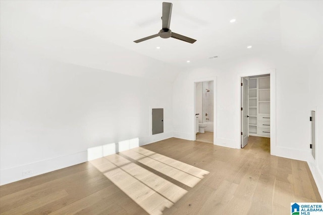 unfurnished bedroom with recessed lighting, light wood-style floors, baseboards, ceiling fan, and a spacious closet