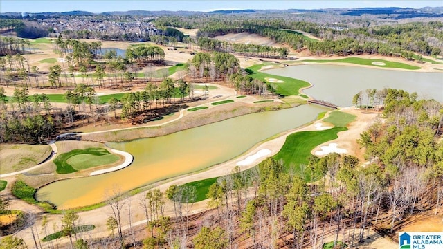 aerial view with golf course view and a water view