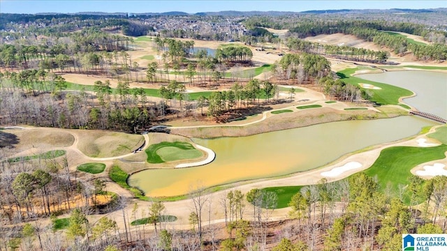 birds eye view of property with golf course view and a water view