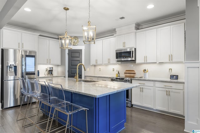 kitchen with appliances with stainless steel finishes, dark wood-style flooring, a sink, and visible vents