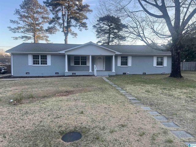 ranch-style house with crawl space, brick siding, a front yard, and fence