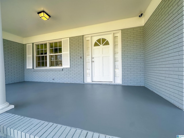 doorway to property with brick siding