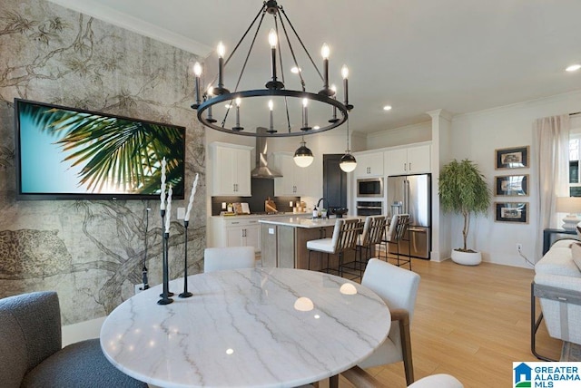 dining room with light wood finished floors, recessed lighting, and crown molding