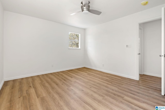 unfurnished room with ceiling fan, light wood-style flooring, and baseboards