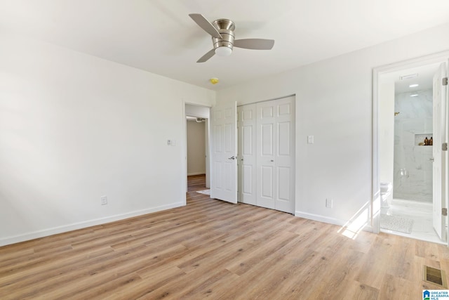 unfurnished bedroom featuring light wood finished floors, baseboards, visible vents, and a closet