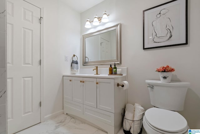 bathroom featuring marble finish floor, baseboards, vanity, and toilet