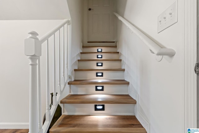 staircase featuring wood finished floors