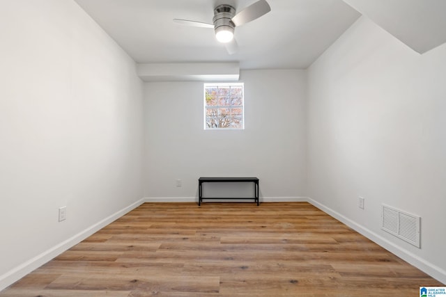 unfurnished room with light wood-type flooring, baseboards, visible vents, and a ceiling fan