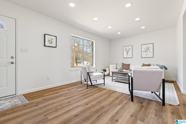 living area with light wood finished floors, baseboards, and recessed lighting